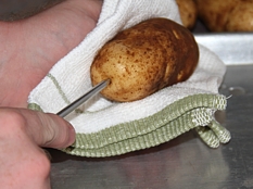Holding potato while inserting Spud Spikes