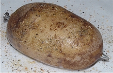 Spud Spikes in a potato with Spud Spikes Potato Seasoning