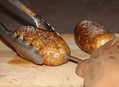 Removing Spud Spikes with tongs and oven mitt
